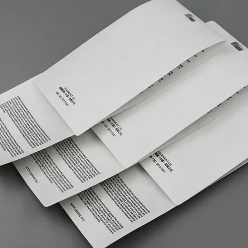 Stack of printed, perforated white papers.